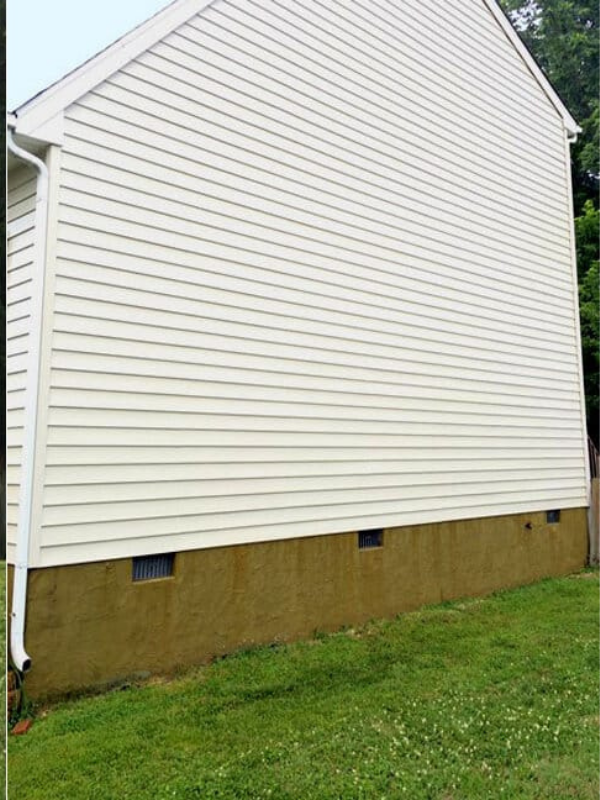 Clean white house siding after professional pressure washing
